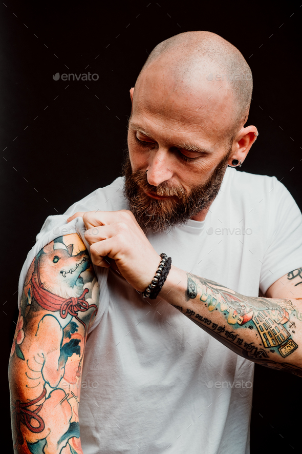 Young bald guy showing tattoos Stock Photo by ADDICTIVE_STOCK | PhotoDune
