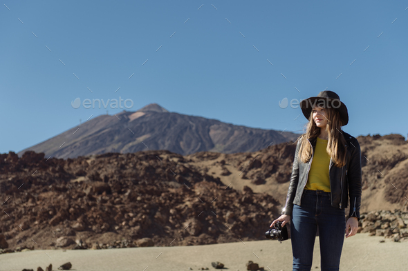 Woman with camera in desert