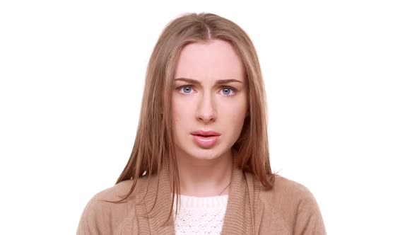 Surprised Beautiful Caucasian Female Standing in Amuzement on White Background in Slowmotion alt