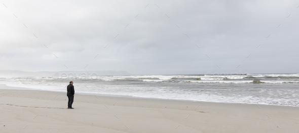 man walking alone on beach