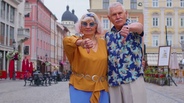 Upset Senior Man Woman Showing Thumbs Down Sign Gesture Expressing Discontent Disapproval Dislike alt