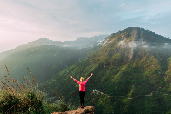 Girl meets sunrise in the mountains. Girl traveling to Sri Lanka. Mountain sports - Stock Photo - Images
