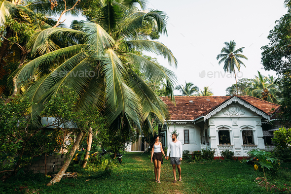 The couple in the home garden. Man and woman rent a house. A couple in love travels - Stock Photo - Images