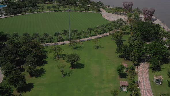 aerial view of a beautifully landscaped park on a clear sunny day with colorful children's playgroun alt