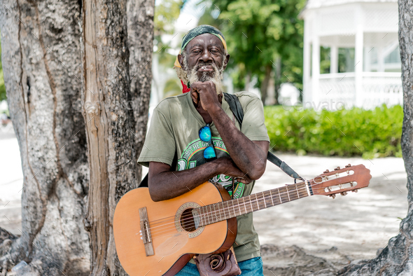Jamaican man playing guitar
