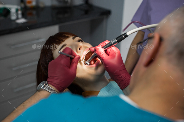 Medical dentist team in modern dental office doing treatment
