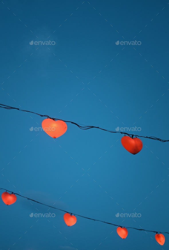 heart shaped lanterns against blue sky Stock Photo by PaulSchlemmer