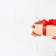 Woman hold christmas gift in the box with red ribbon. - PhotoDune Item for Sale