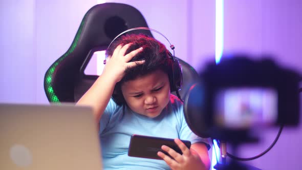 Asian Little Boy Playing Video Game With Mobile Phone Then Lose The Game While Live Stream alt