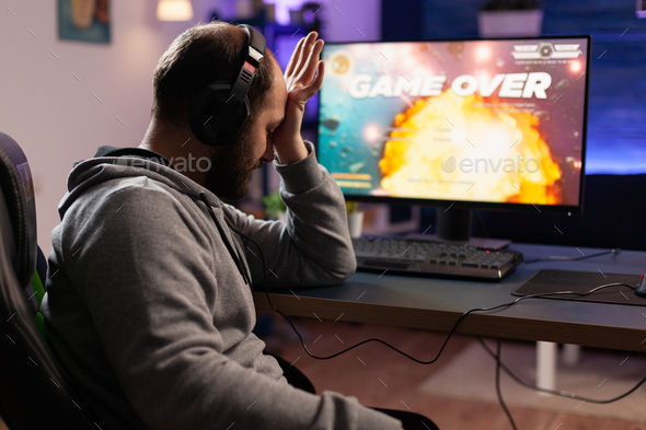 Sad gamer losing video games play on computer