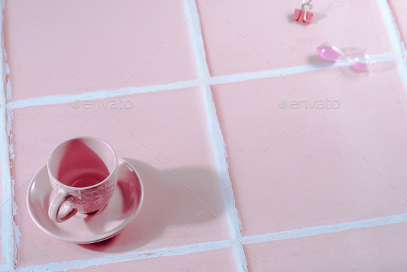 the pink hourglass and pink cup on pink background - Stock Photo - Images