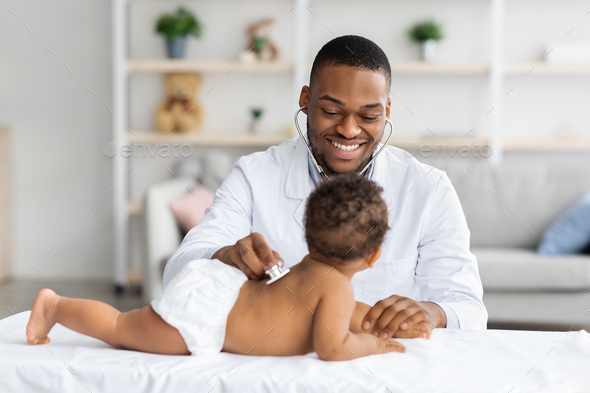 Medical Checkup. Smiling Black Pediatrician Doctor Examining Little ...