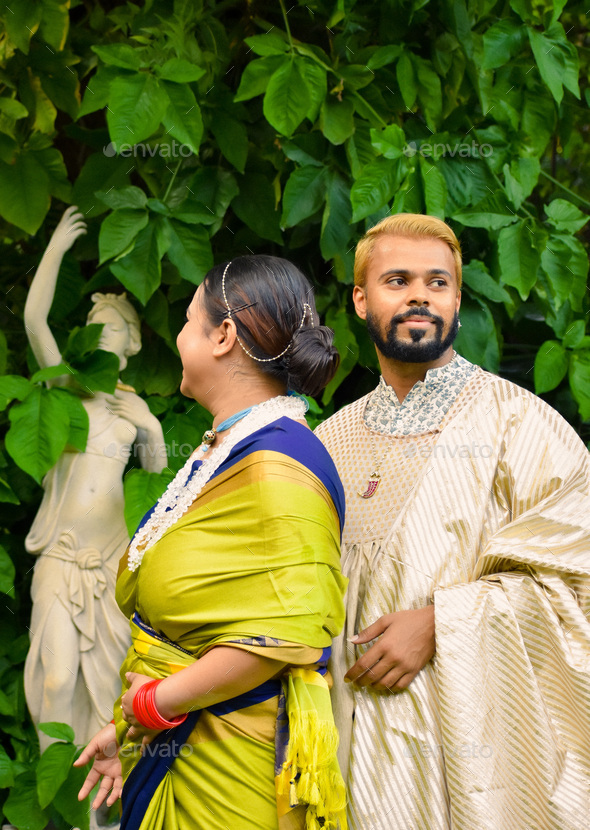 Indian man and woman in traditional festive outfit standing outd