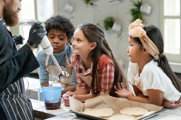 Children baking cookies with chef