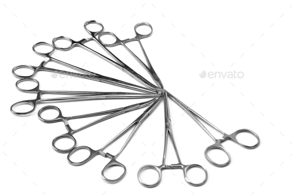 Surgical needle drivers forceps on white background. Lot of steel medical instruments needle holders