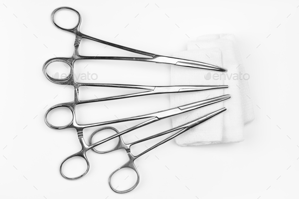 Surgical needle drivers lying on gauze swab. Medical instruments needle holders on white background