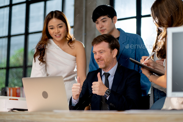 Business manager show thumbs up and stay with his team during online meeting