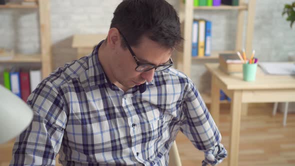 Portrait Male Office Worker with an Amputated Hand in the Workplace alt
