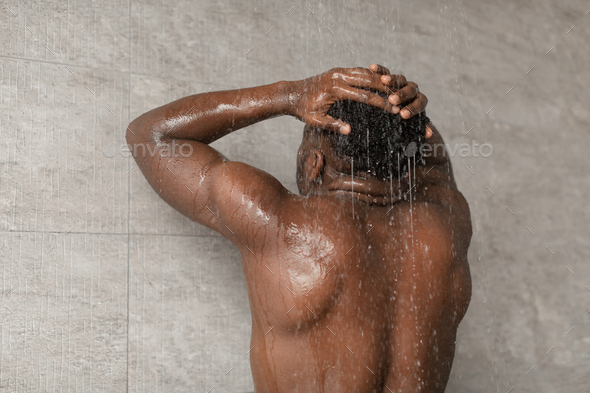 Unrecognizable African American Guy Taking Shower Washing Head At Home