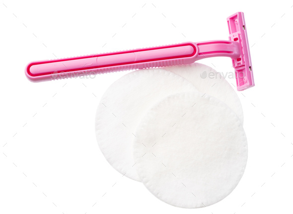 Cotton pads and disposable razor isolated on white