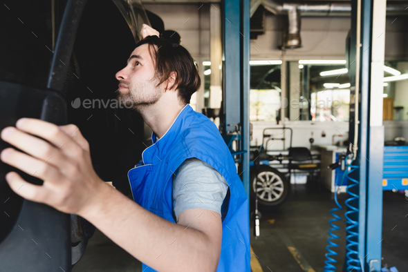 MOT. Vehicle inspection. Car technician mechanic fixing repairing car automobile before test drive.