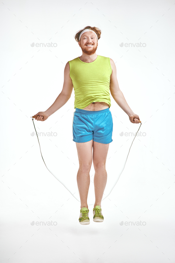 Red haired, bearded, plump man holding skipping rope