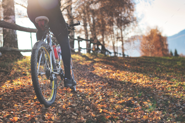 Passage of a mountain bike on leafy paths in the hills - Stock Photo - Images