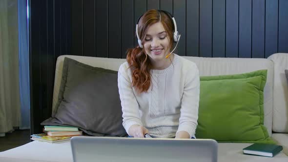 Young Smiling Student Wearing Headphones Communicating By Video Call Doing Distant Chat alt