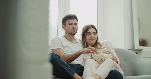 Romantic Time Hugging Couple in Pajamas Sitting on alt