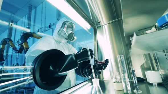 Laboratory Worker is Using a Vacuum Cabinet for Research of Probes alt