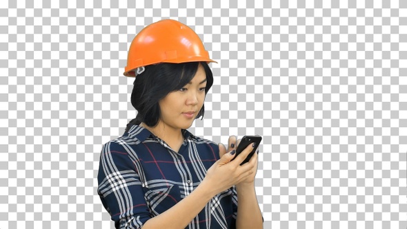 Female architect with orange helmet using smartphone, Alpha Channel