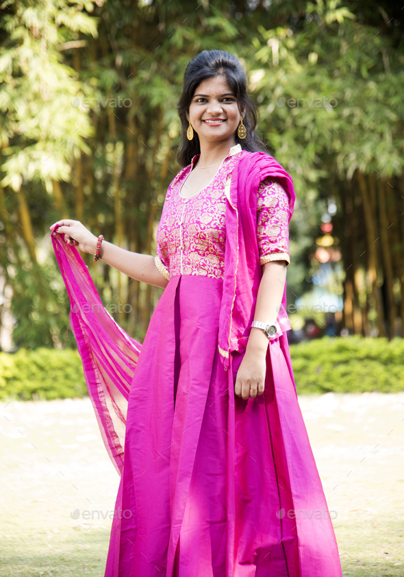 Outdoor portrait of beautiful young Indian girl in traditional dress ...