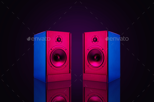 Two stereo speakers with neon light on dark background