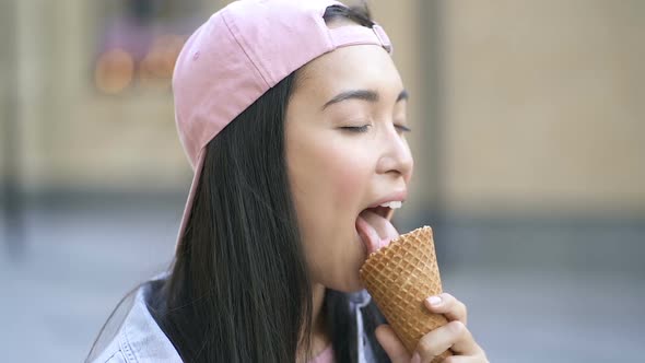 Asian woman licking and eating icecream