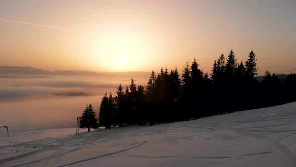 Flying Over Clouds in the Winter Morning Sunrise in Carpathian Mountains alt