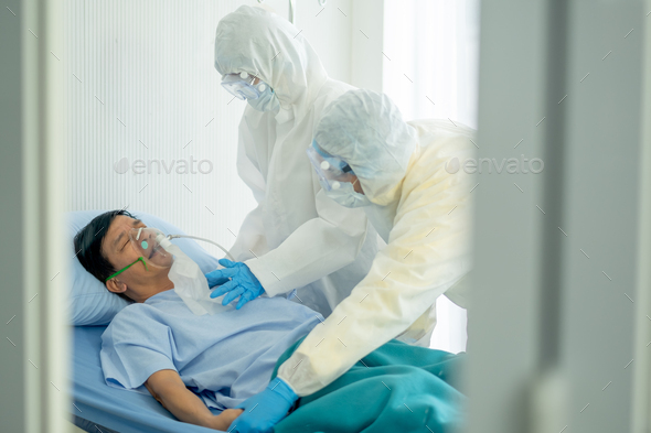 Doctor and nurse with full body cover suit take care and help virus infected patient