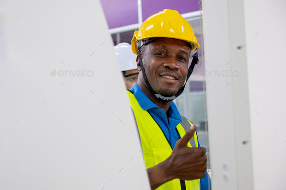 African American factory worker man smile and show thumbs up to camera