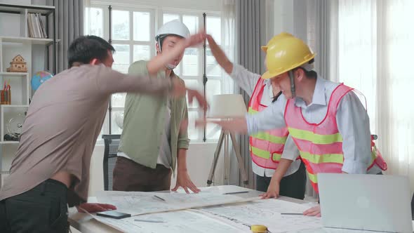 Engineers With Helmets And A Man Celebrating Finish Drawing Building Construction While Working alt