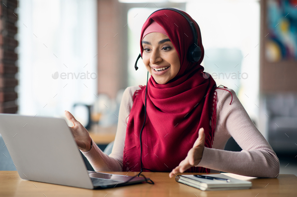 Cheerful muslim lady having video conference with clients - Stock Photo - Images