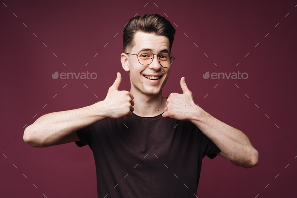 Happy handsome man showing thumbs up