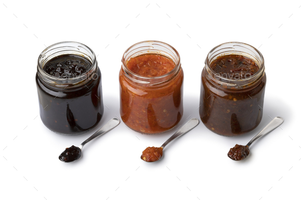 Glass jars with variation of sambal, chili sauce, on white background - Stock Photo - Images