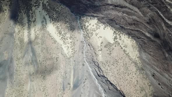 Overhead aerial drone clip over a mountainous barren volcanic area 6 4k