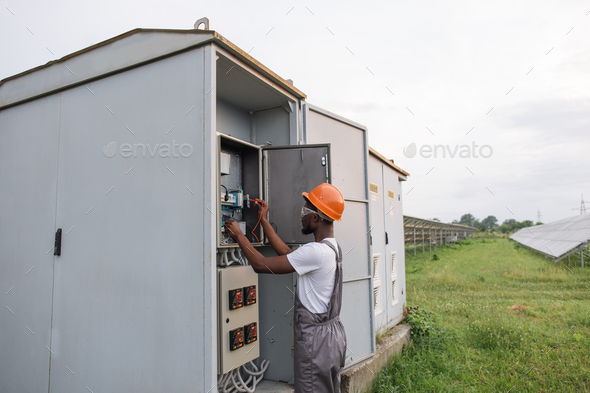 African electrician doing service work on solar station