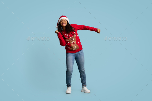 Emotional african american woman having New Year disco on blue