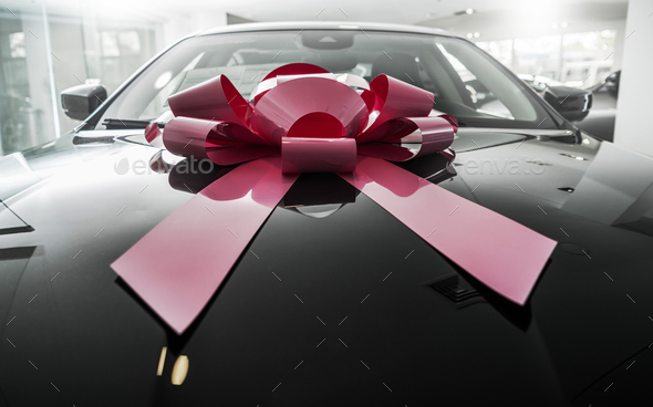 Brand New Elegant Car with Large Gift Bow - Stock Photo - Images