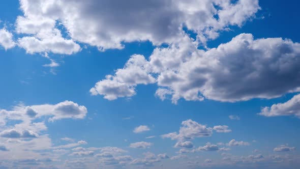 White Clouds Move and Dissolve in the Blue Sky Timelapse alt