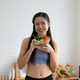 young Asian woman cooking vegetable healthy food and eating or drinking in home kitchen - PhotoDune Item for Sale
