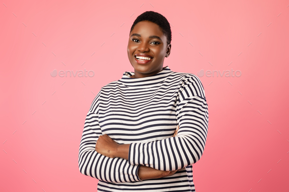 Overweight African Woman With Short Haircut Posing Over Pink Background