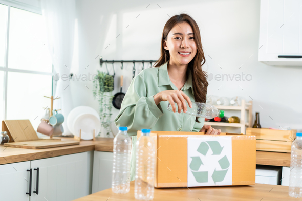 Portrait of Asian woman hold trash bin for further recycling at home. - Stock Photo - Images