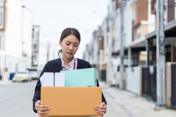Asian upset business woman walk outdoor after unemployment from company. - Stock Photo - Images